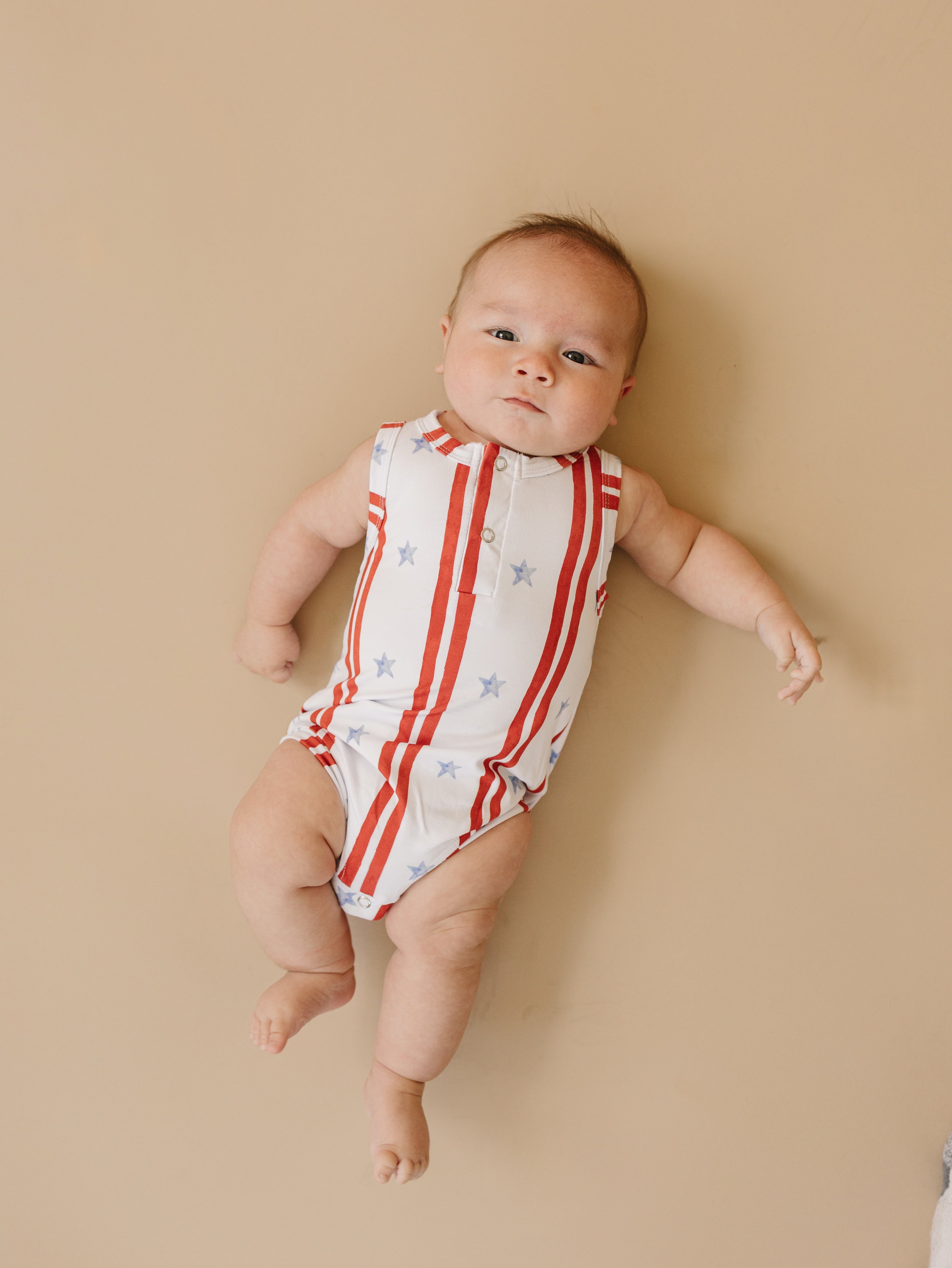 Baby wearing a bamboo henley romper